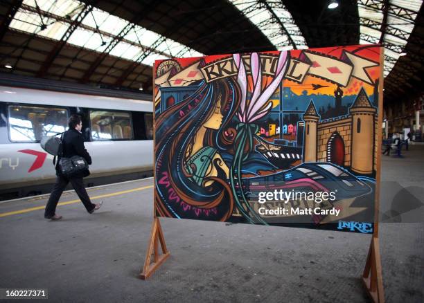 Rail users walk past a piece of graffiti art by Bristol born artist Inkie, which was unveiled to launch a brand new creative commissioning project...