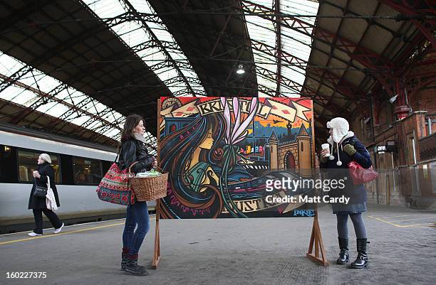 Rail users Lizzie Jones and Jools Samson stop to look at piece of graffiti art by Bristol born artist Inkie, which was unveiled to launch a brand new...
