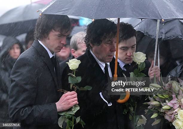 The sons of convicted Old Bailey bomber Dolours Price, Danny and Oscar , stand with her ex-husband Stephen Rea , at Milltown cemetary in Belfast,...