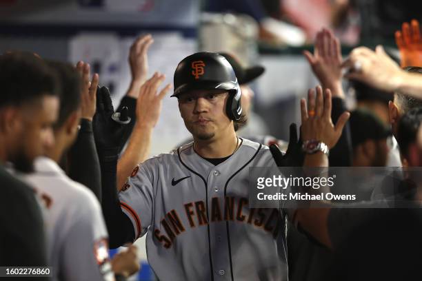 Wilmer Flores of the San Francisco Giants celebrates with teammates after hitting a two run home run against the Los Angeles Angels during the eighth...