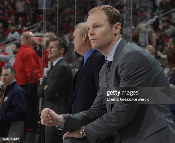 Assitant coach Kevyn Adams of the Buffalo Sabres watchs action on the ice during their NHL game against the Carolina Hurricanes at PNC Arena on...