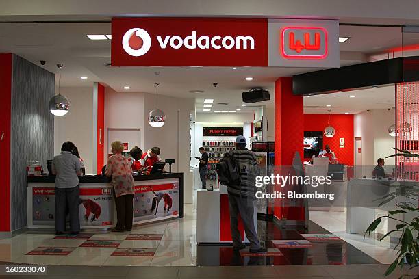 Customers browse inside a Vodacom store inside Vodaworld, the headquarters of Vodacom Group Ltd., Vodafone's biggest African business, in...