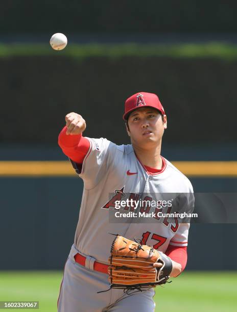 Shohei Ohtani of the Los Angeles Angels throws a warm-up pitch at the start of the 8th inning of game one of a doubleheader against the Detroit...