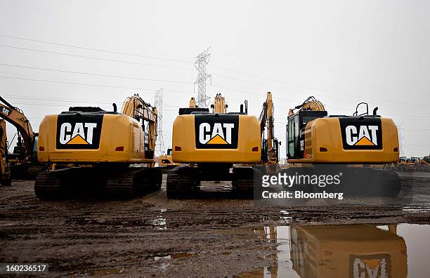 Caterpillar Inc. Excavators sit on display at a Patten Industries Inc. Dealership in Elmhurst, Illinois, U.S., on Monday, Jan. 28, 2013. Caterpillar...