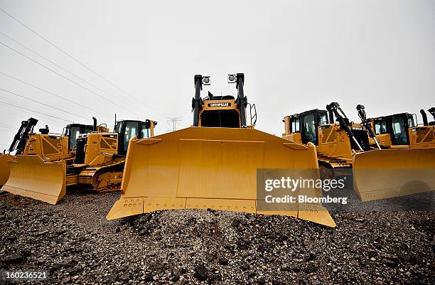 Caterpillar Inc. Bulldozers, including a model D6T LGP, center, sit on display at a Patten Industries Inc. Dealership in Elmhurst, Illinois, U.S., on...