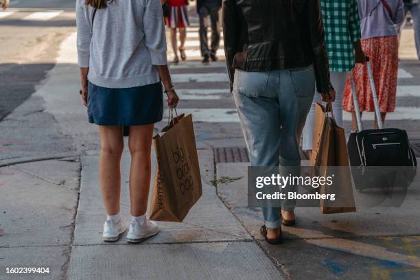 Shoppers carry Bloomingdale's bags in the Magnificent Mile shopping district in Chicago, Illinois, US, on Tuesday, Aug. 15, 2023. US retail sales...