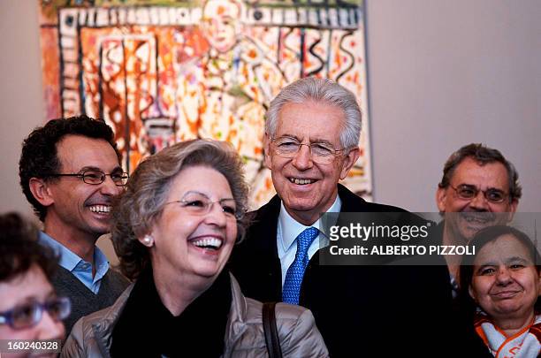 Italy's outgoing Prime Minister and leader of a centrist coalition for early elections in February, Mario Monti poses with his wife Elsa during a...