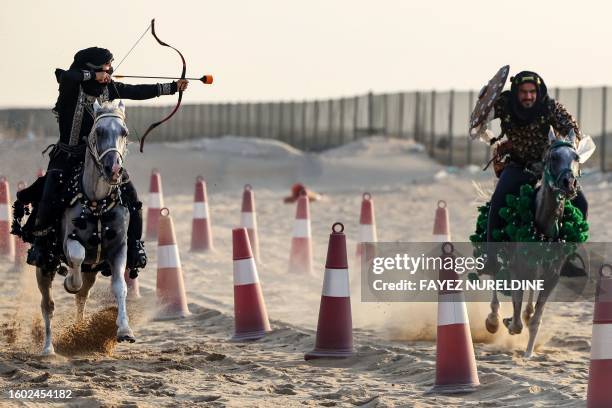 Saudi equestrian Noura Al-Jabr and a fellow rider demonstrate their skills at a training centre in Dammam, in Saudi Arabia's eastern province on...