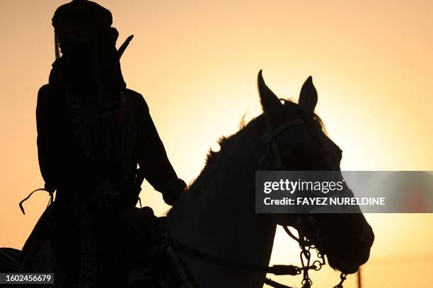 Saudi equestrian Noura Al-Jabr rides her horse at a training centre in Dammam, in Saudi Arabia's eastern province on August 14, 2023. Jabr organises...