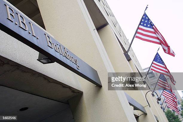 American flags fly over the Federal Bureau of Investigation building July 18, 2001 in Washington, D. C. The agency announced on that 449 of its...