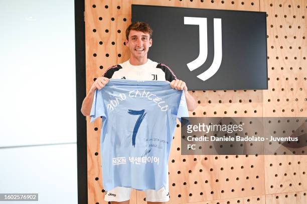 Andrea Cambiaso of Juventus receives Joe Cancelo jersey during a training session at JTC on August 16, 2023 in Turin, Italy.
