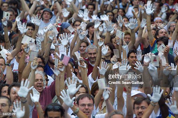Pro-immigration activists with white-stained hands take part in an anti-G8 demonstration July 19, 2001 in Genoa, Italy on the eve of the G8 summit....