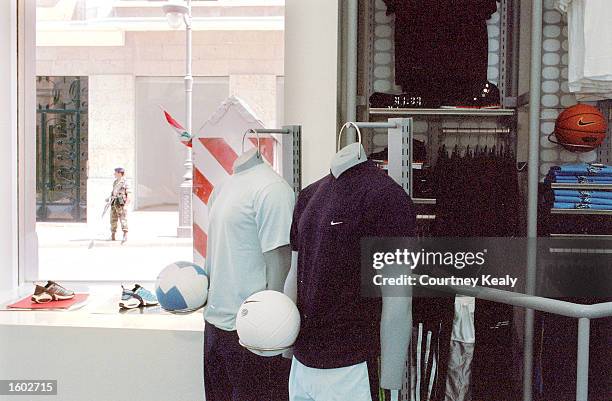 Lebanese soldier stands guard outside the new Nike Sportstown July 17, 2001 in the reborn downtown area of Beirut which has undergone ten years of...