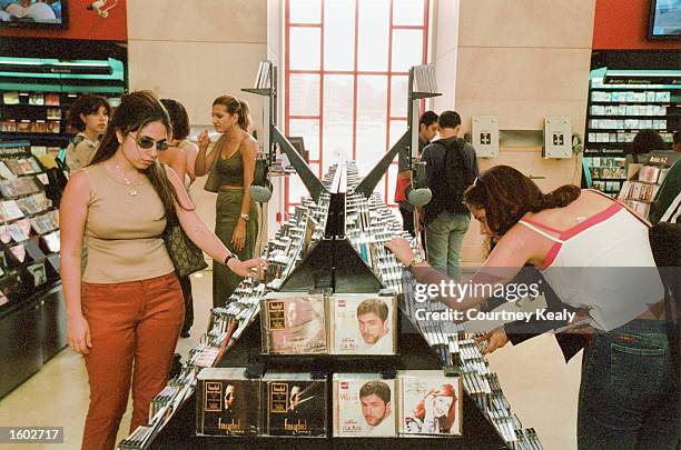 Shoppers look over merchandise July 17, 2001 at a Virgin Megastore, the first one in the Middle East, which recently opened in the reborn downtown...