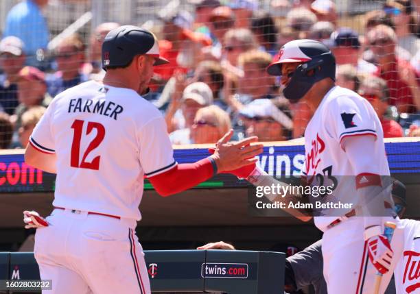 Kyle Farmer of the Minnesota Twins scores on a Jorge Polanco sacrifice in the second inning against the Detroit Tigers at Target Field on August 16,...