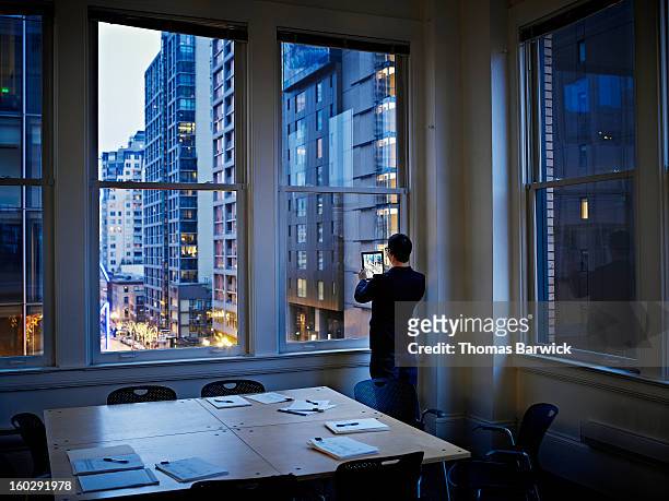 Businessman taking digital photo of cityscape