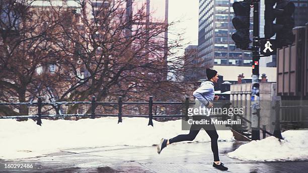 a man running in the winter snow - winter quebec stock pictures, royalty-free photos & images