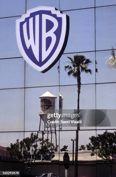 View of the Warner Brothers logo on a building with a palm tree in the reflection in April 1991 in Burbank, California.