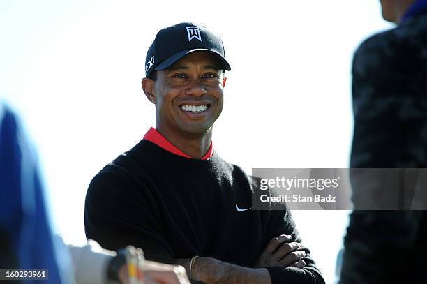 Tiger Woods smilies as he waits to play the 18th hole during the final round of the Farmers Insurance Open at Torrey Pines Golf Course on January 28,...