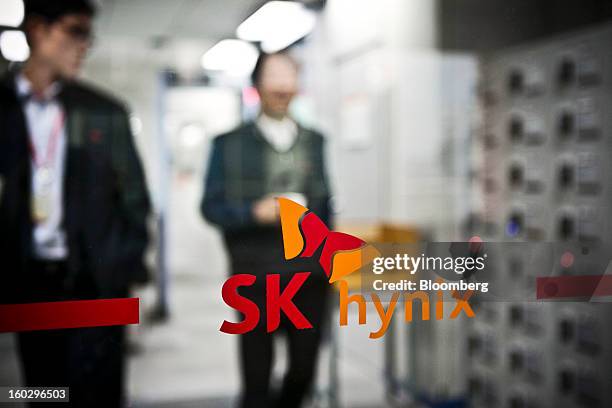 The SK Hynix Inc. Logo is displayed on a glass door at the company's headquarters in Seoul, South Korea, on Monday, Jan. 28, 2013. Hynix is scheduled...