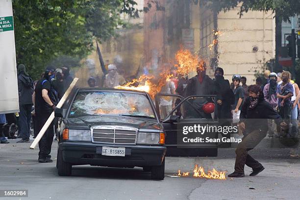 Anti-G8 protesters set a Mercedes Benz alite July 20, 2001 in central Genoa. Approximately 600 violent protesters fought with police, torched cars...