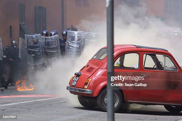 Police advance through clouds of tear gas toward anti-G8 protesters July 20, 2001 in central Genoa. Approximately 600 violent protesters fought with...