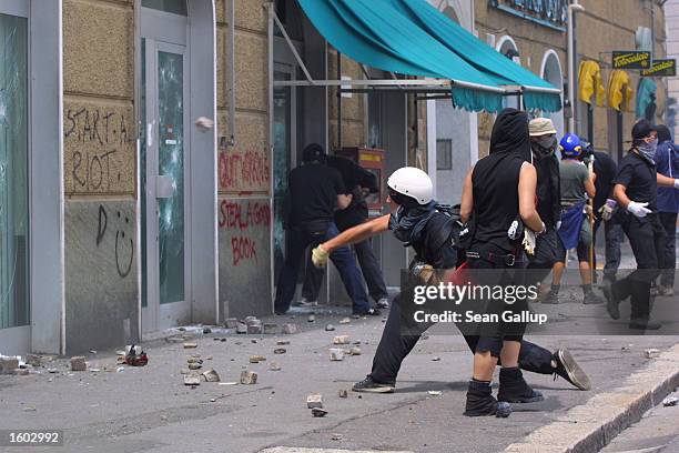 Anti-G8 protesters smash shops July 20, 2001 in central Genoa. Approximately 600 violent protesters fought with police, torched cars and looted shops...