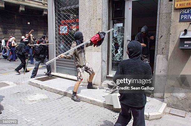 Anti-G8 protesters smash a car rental store July 20, 2001 in central Genoa. Approximately 600 violent protesters fought with police, torched cars and...