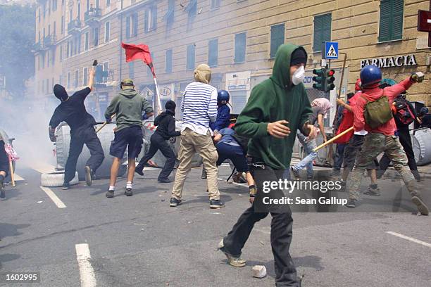 Anti-G8 protesters battle police July 20, 2001 in central Genoa. Approximately 600 violent protesters fought with police, torched cars and looted...