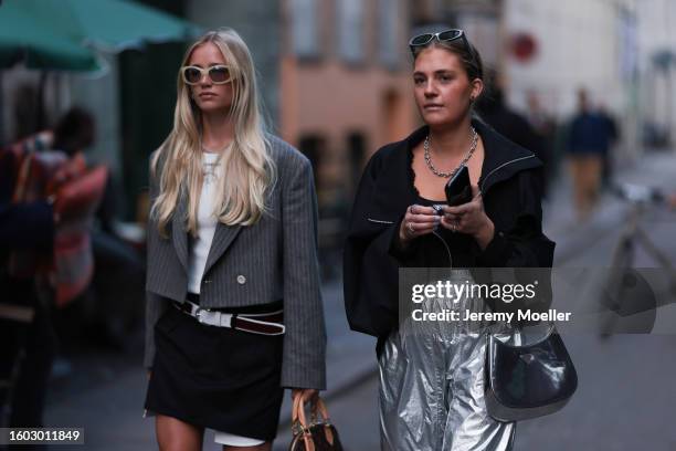 Guest seen wearing light beige / latte oval sunglasses, silver necklace, white printed cropped t-shirt, grey striped cropped blazer jacket, white...