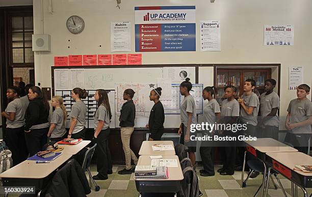 Eighth grade students line up for lunch with the school motto above their heads at UP Academy, which was converted from the old Gavin Middle School...