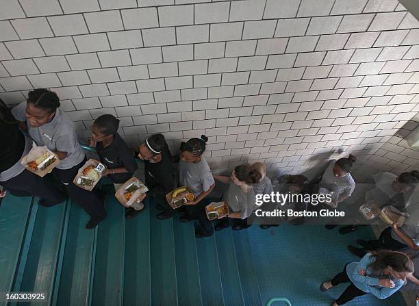 Eight grade students returning from lunch walk up a stairway with teacher Christine Adamson at UP Academy, which was converted from the old Gavin...