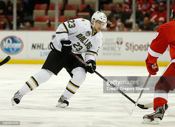 Tom Wandell of the Dallas Stars looks to make a play against Patrick Eaves of the Detroit Red Wings at Joe Louis Arena on January 22, 2013 in...