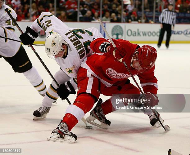 Justin Abdelkader of the Detroit Red Wings faces off against Tom Wandell of the Dallas Stars at Joe Louis Arena on January 22, 2013 in Detroit,...