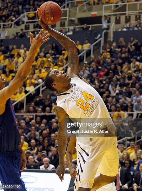 Aaric Murray of the West Virginia Mountaineers is fouled while bring down a rebound against the Kansas Jayhawks at the WVU Coliseum on January 28,...