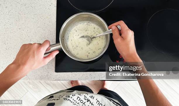 decoction of moss with hot milk - roer stockfoto's en -beelden