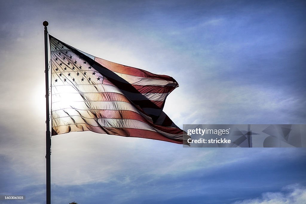 US Flag Fluttering in Backlit Blue Sky Symbolizing Government Transparency