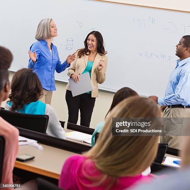 professor introducing guest speaker in college lecture hall - college visit stock pictures, royalty-free photos & images