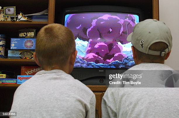 Two young boys watch a Pokemon video in their parent''s home July 20, 2001 in Des Plaines, IL home.