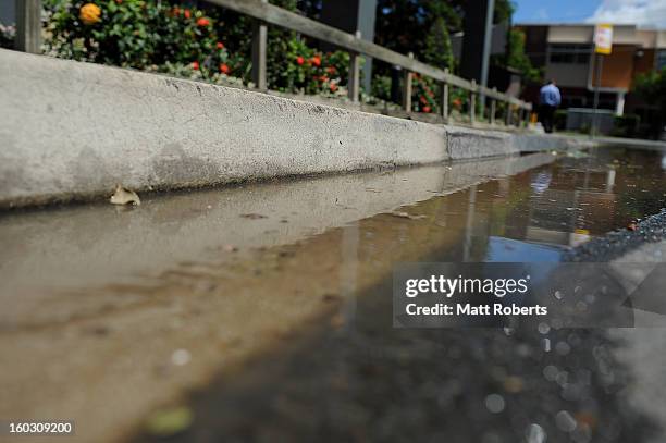 Water begins to seep out of the drains in the inner city suburb of Milton as parts of southern Queensland experiences record flooding in the wake of...