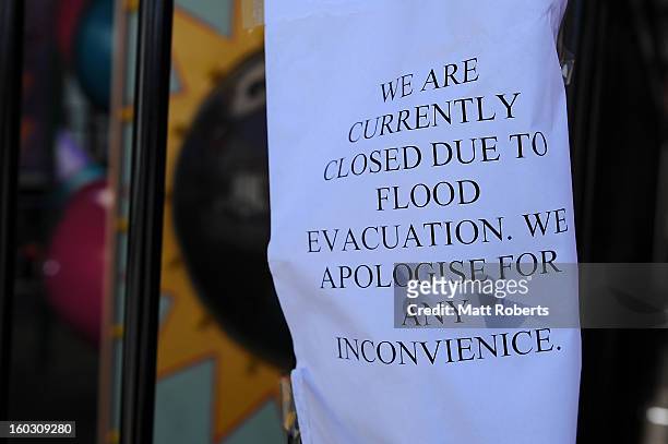 Sign is seen on a closed shop in the inner city suburb of Milton as parts of southern Queensland experiences record flooding in the wake of Tropical...