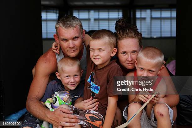 Tamara and Cal Lovett and their three boys Ryan, Toby and Liam photographed at a temporary evacuation centre as parts of southern Queensland...