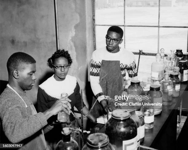 Claflin University students doing experiment with chemicals in laboratory in the 1960s.