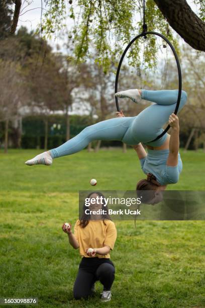 two acrobat young women. - lyra stock pictures, royalty-free photos & images
