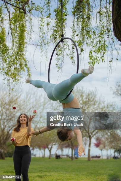 two acrobat young women. - lyra stock pictures, royalty-free photos & images