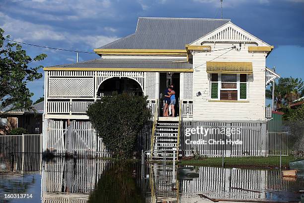 Residents look on as floods suround their house as parts of southern Queensland experiences record flooding in the wake of Tropical Cyclone Oswald on...