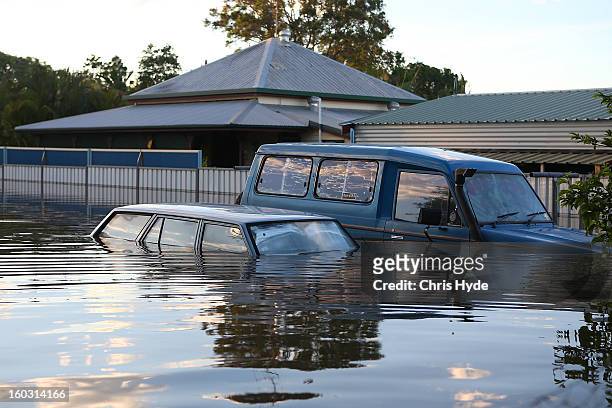 Cars float in a flooded street as parts of southern Queensland experiences record flooding in the wake of Tropical Cyclone Oswald on January 29, 2013...