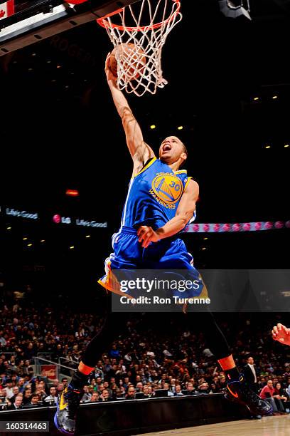 Stephen Curry of the Golden State Warriors rises for a dunk against the Toronto Raptors on January 28, 2013 at the Air Canada Centre in Toronto,...