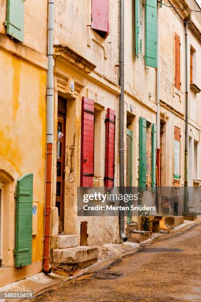 colorful plaster and window shutters - arles stock pictures, royalty-free photos & images