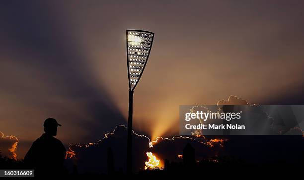 The sun sets as Manuka Oval hosts cricket under lights for the first time during the International Tour Match between the Prime Minister's XI and...